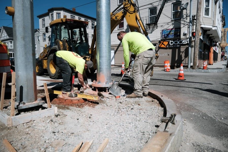 Men work on a construction project on 9 April 2021 in Central Falls, Rhode Island. Looking to reshape the U.S. economy, President Joe Biden has recently unveiled a $2 trillion jobs, infrastructure and green energy plan called the American Jobs Plan. (Spencer Platt/AFP)