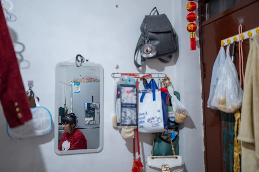 Sister Chen’s belongings hang on the wall in her rented lodgings.