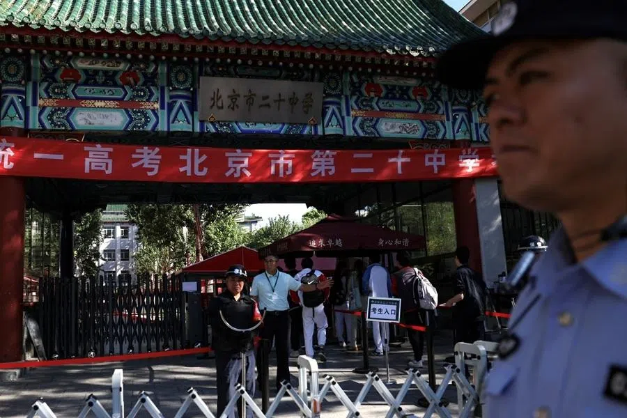 A police officer patrols around a high school, one of the venues for the annual national college entrance exam, or "gaokao", in Beijing, China, 7 June 2026.