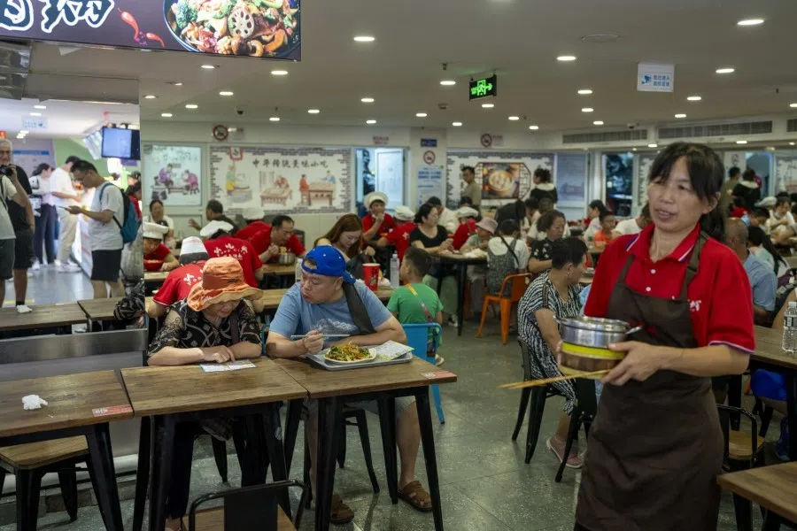 Customers at a food stall in Shanghai, China, on 7 August 2023. (Raul Ariano/Bloomberg)