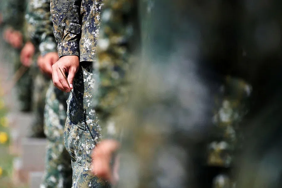 Soldiers hold incense to pay their respects to the deceased during an event to mark the 62nd anniversary of the Second Taiwan Strait crisis in Kinmen, Taiwan, 23 August 2020. (Ann Wang/Reuters)