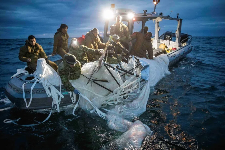 Sailors assigned to Explosive Ordnance Disposal Group 2 recover a suspected Chinese high-altitude surveillance balloon that was downed by the United States over the weekend over US territorial waters off the coast of Myrtle Beach, South Carolina, US, 5 February 2023. (US Fleet Forces/US Navy photo/Handout via Reuters)