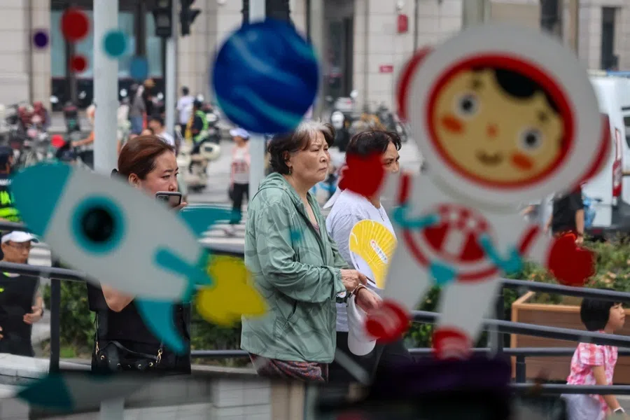 People are seen through a window with stickers depicting planets, rockets and an astronaut at a space-themed pop-up cafe during Dragon Boat Festival celebrations in Beijing's Tongzhou district, China, on 19 June 2026.