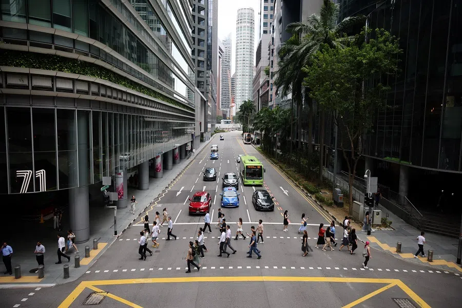 Office workers crossing a street at Singapore’s central business district on 21 August 2024. (SPH Media)