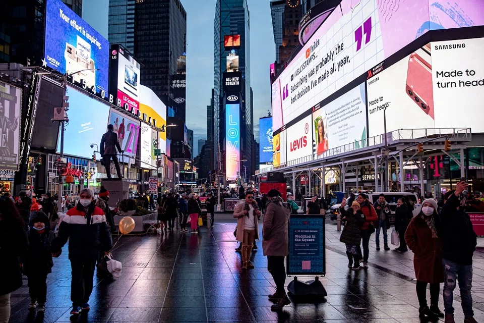 People walk in Times Square in Manhattan, New York City, New York, US, 14 February 2021. (Jeenah Moon/Reuters)