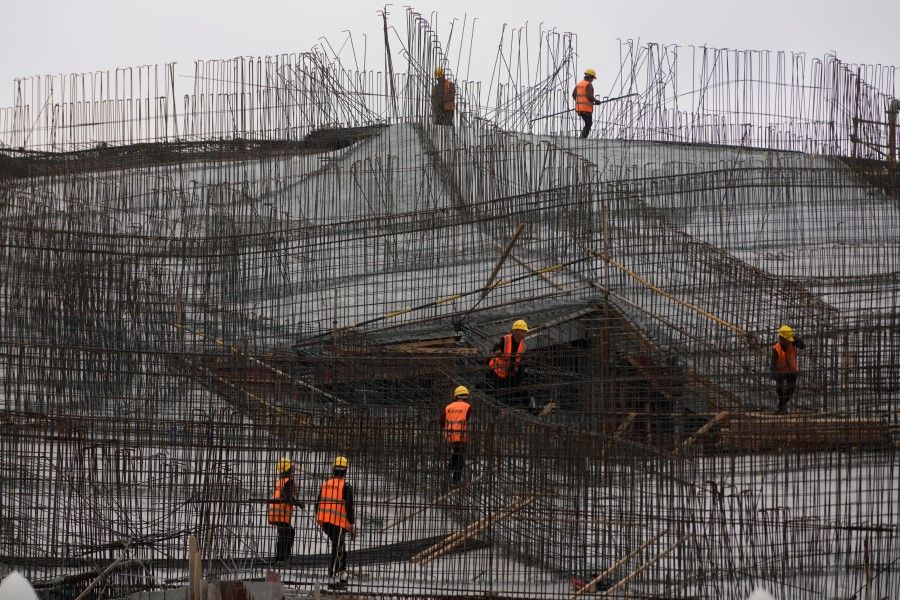 Workers work at a construction site, following the Covid-19 outbreak, in Shanghai, China, 14 October 2022. (Aly Song/Reuters)
