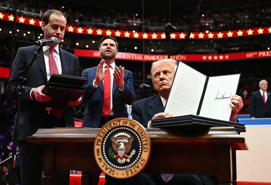 US President Donald Trump holds an executive order announcing the US withdrawal from the Paris Agreement, he just signed during the inaugural parade inside Capital One Arena, in Washington, DC, on 20 January 2025. (Jim Watson/AFP)