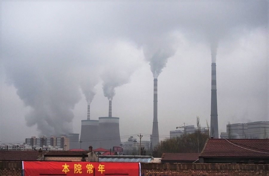 This file photo taken on 19 November 2015 shows smoke belching from a coal-fired power station near Datong, Shanxi province, China. (Greg Baker/AFP)