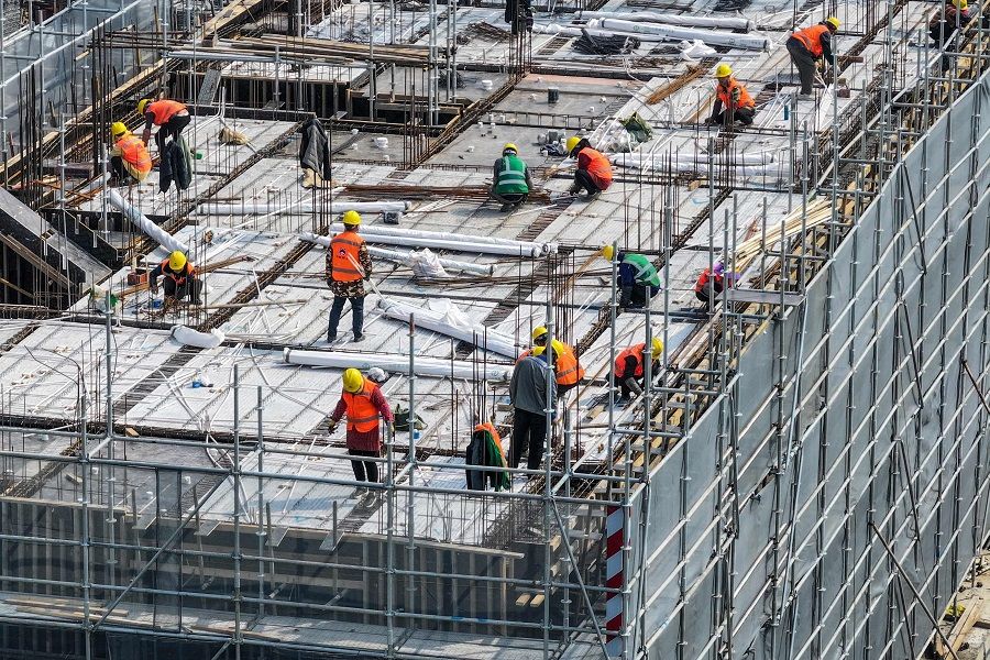Workers are seen on a rooftop of a residential building under construction in Nanjing, Jiangsu province, China, on 7 March 2024. (AFP)