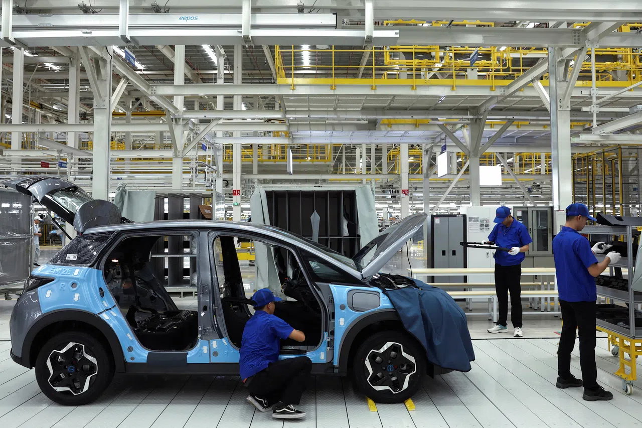 Workers assemble an EV car inside BYD’s first EV factory in Southeast Asia, a fast-growing regional EV market where it has become the dominant player, in Rayong, Thailand, on 4 July 2024.  (Chalinee Thirasupa/Reuters)