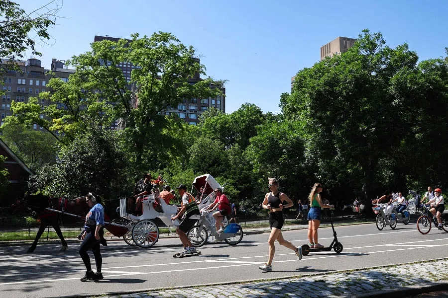People cycle and run in Central Park in the Manhattan borough of New York city during Memorial Day weekend on 26 May 2024. (Charly Triballeau/AFP )