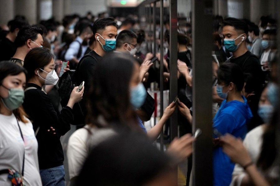 Commuters wearing face masks wait for their ride at a subway station, after the lockdown placed to curb the Covid-19 outbreak was lifted in Shanghai, China, 1 June 2022. (Aly Song/Reuters)