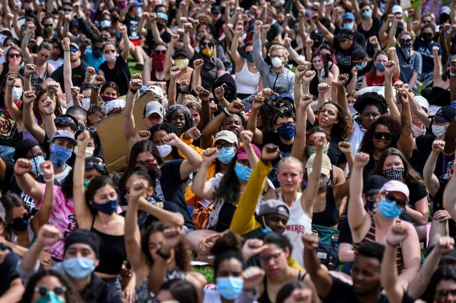 Demonstrators raise their fists as they gather on 2 June 2020 in Saint Paul, Minnesota, to protest the death of George Floyd while in police custody. (Chandan Khanna/AFP)