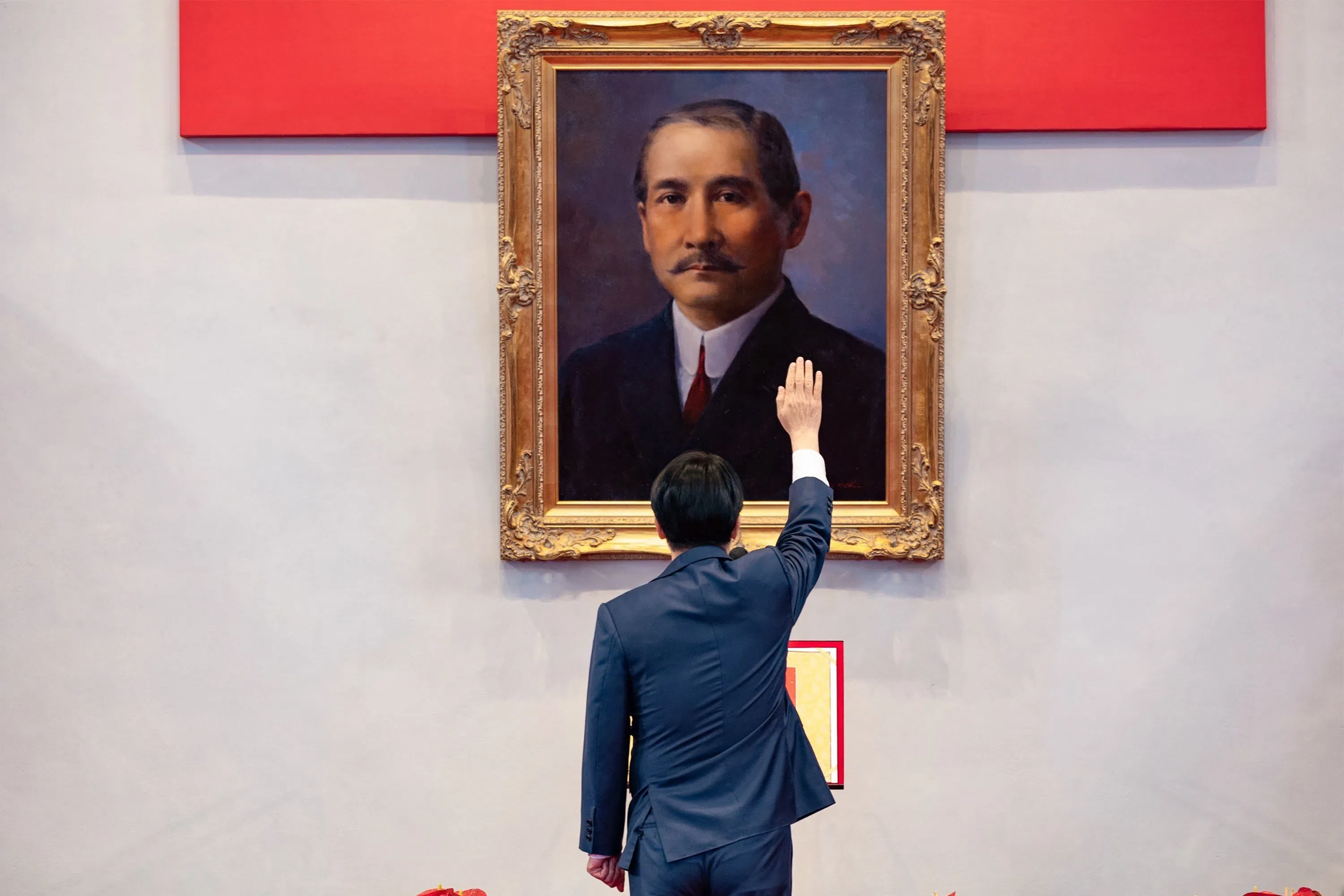 This handout photo released by the Taiwan Presidential Office on 20 May 2024 shows Taiwan’s President William Lai taking his oath in front of a portrait of Sun Yet-sen, father of modern China, during the inauguration ceremony at the Presidential Office Building in Taipei. (Taiwan Presidential Office/AFP)
