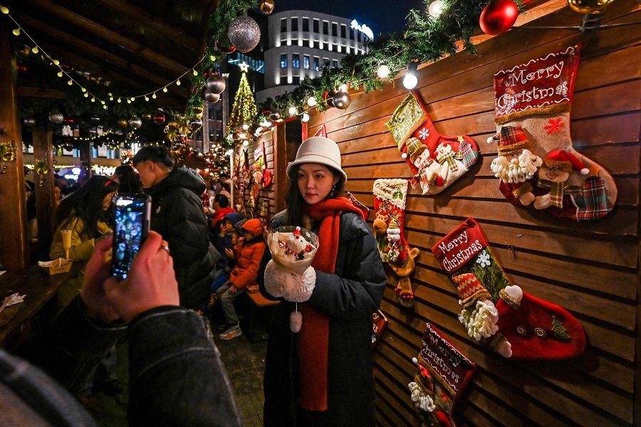 People visit a Christmas market in the Huangpu district in Shanghai on 23 December 2023. (Hector Retamal/AFP)