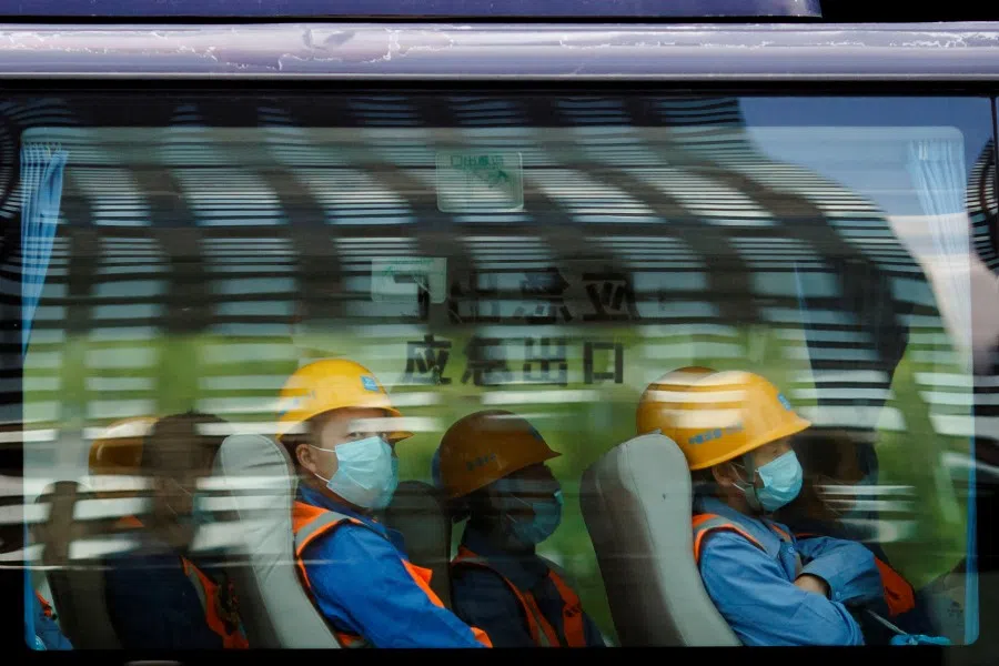 Workers leave a construction site at the end of their shift in the Central Business District in Beijing, April 16, 2020. (Thomas Peter/REUTERS)