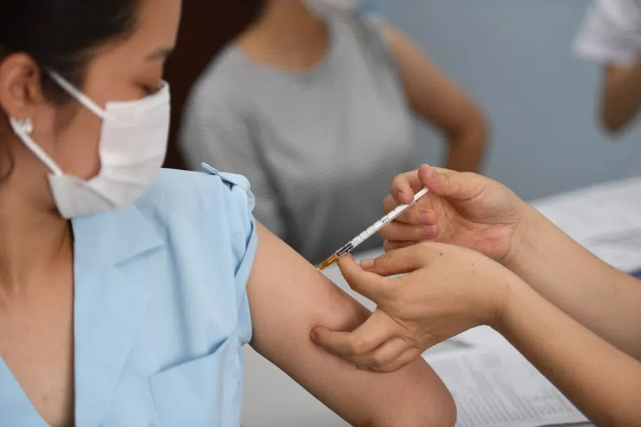 A woman receives a dose of the AstraZeneca vaccine for the Covid-19 coronavirus at the Bach Mai Hospital in Hanoi on 17 May 2021. (Nhac Nguyen/AFP)