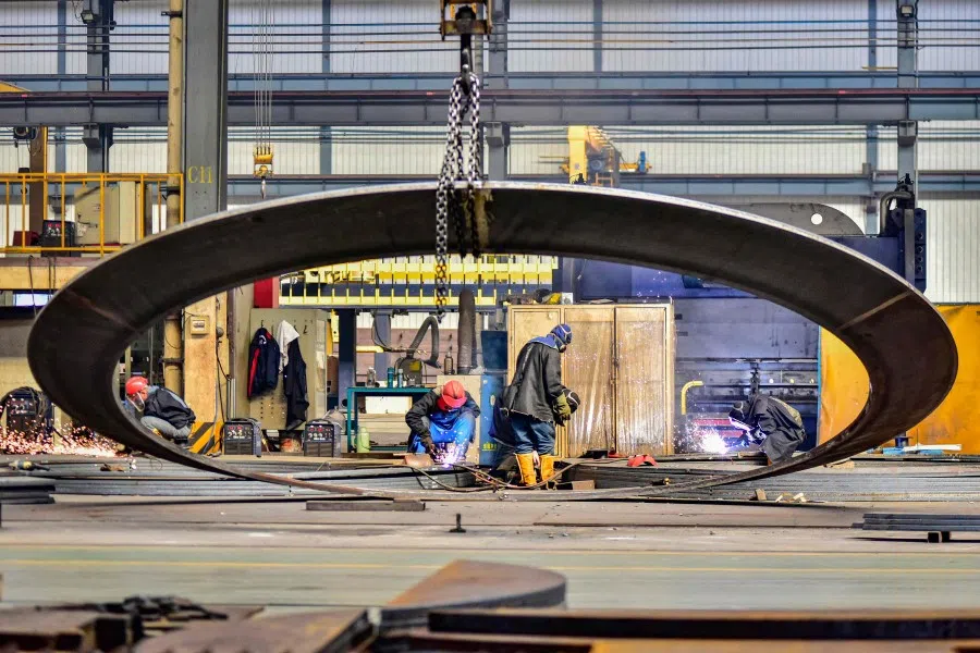 Employees work at a wind turbine manufacturing factory in Qingzhou, in eastern China's Shandong province, on 18 March 2024. (AFP)