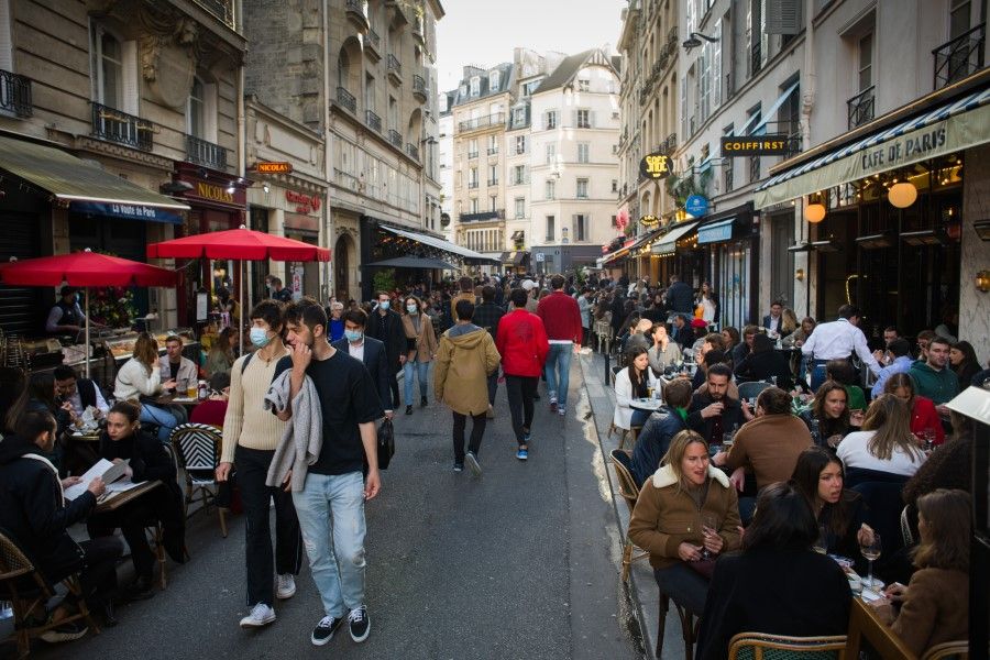Customers drink on reopened cafe terraces on Saint Germain in Paris, France, on 19 May 2021. (Nathan Laine/Bloomberg)