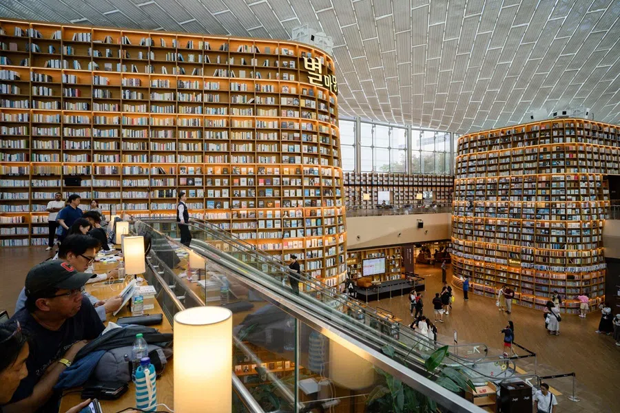 People visit Starfield Library at the COEX Mall in Seoul on 25 September 2025. (Anthony Wallace/AFP)