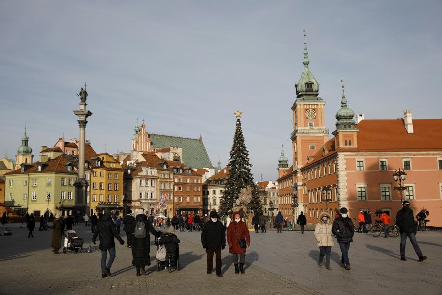 People walk at Castle Square in the Old Town, amid the coronavirus disease (COVID-19) outbreak in Warsaw, Poland, 27 December 2020. (Kacper Pempel/REUTERS)