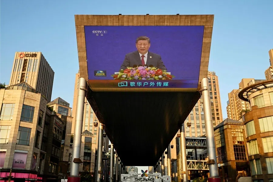 A news program shows China’s President Xi Jinping speaking on a giant screen outside a shopping mall in Beijing on 17 July 2026.