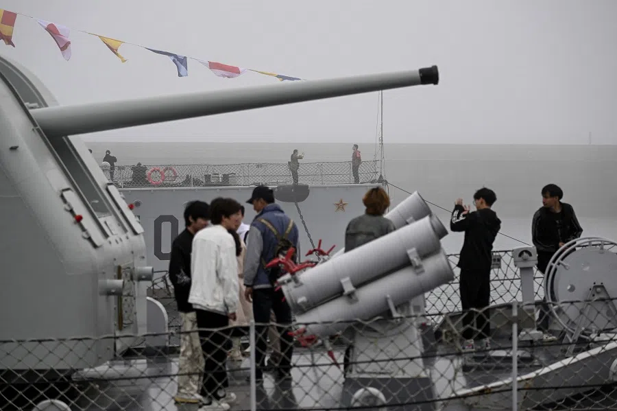 This picture taken during a media tour organised by the PLAN to mark its 75th founding anniversary, shows people visiting a destroyer at the PLA Naval Museum in Qingdao, China’s Shandong province, on 23 April 2024. (Wang Zhao/AFP)