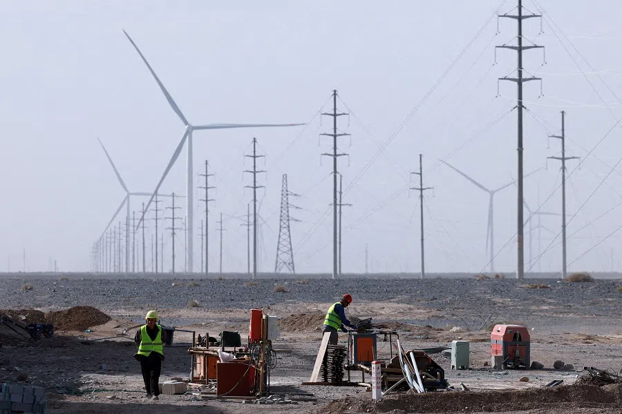 Workers at a construction site at a Taiyuan New Energy Co wind farm, during an organised media tour in Jiuquan, Gansu province, China, on 17 October 2024. (Tingshu Wang/Reuters)