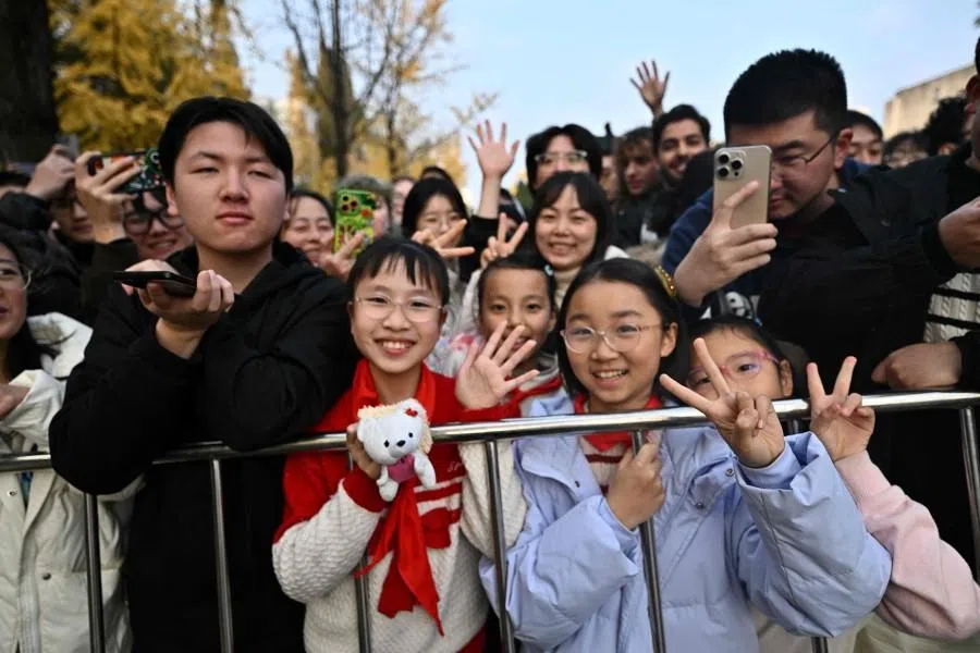 People gather to see French President Emmanuel Macron at the University of Sichuan after a meeting with students in Chengdu, in southwestern China’s Sichuan province on 5 December 2025.
