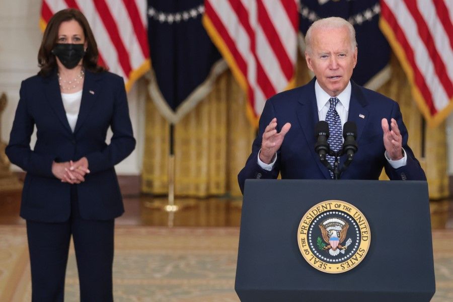 US President Joe Biden speaks in the East Room of the White House with Vice-President Kamala Harris (left) in Washington, DC, US, on 10 August 2021.(Oliver Contreras/Bloomberg)