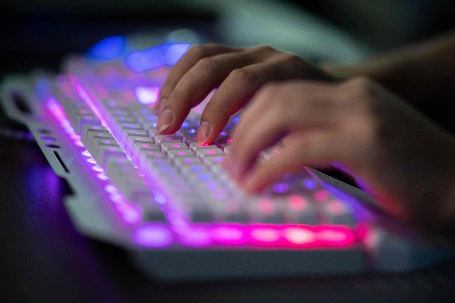 This photo taken on 4 August 2020 shows a user on a keyboard. It is common for users in China to access the internet through VPN. (Nicolas Asfouri/AFP)
