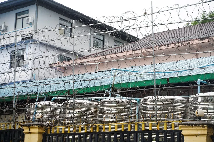 Barbed wire fences are seen outside a shuttered Great Wall Park compound where Cambodian authorities said they had recovered evidence of human trafficking, kidnapping and torture during raids on suspected cybercrime compounds in the coastal city of Sihanoukville, Cambodia, 21 September 2022. (Cindy Liu/Reuters)