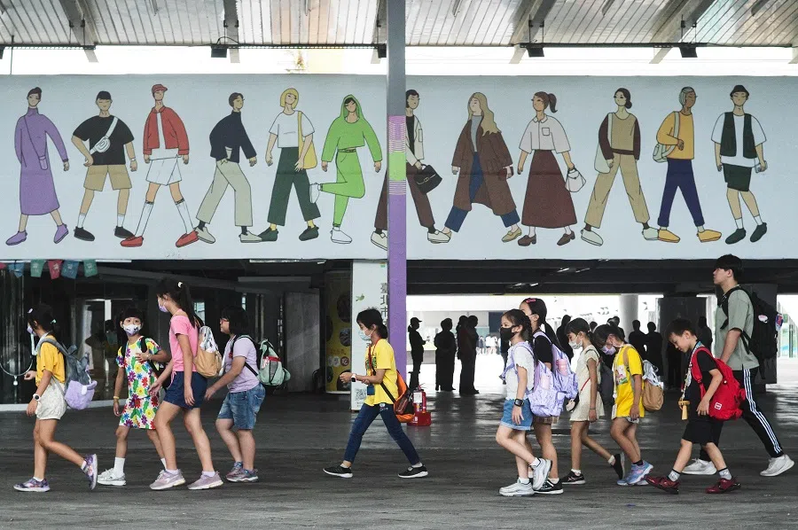 Students walk past a mural painting in Taipei on 6 August 2024. (Sam Yeh/AFP)