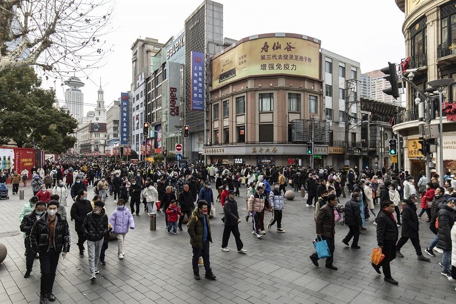 Pedestrians on Nanjing Road in Shanghai, China, on 2 February 2022. (Qilai Shen/Bloomberg)