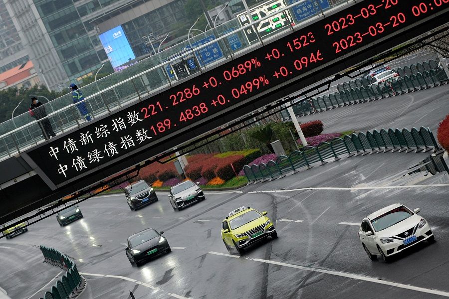An electronic board shows stock indexes at the Lujiazui financial district in Shanghai, China, 21 March 2023. (Aly Song/Reuters)