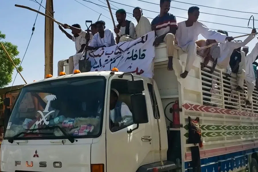 People form a convoy as they celebrate in support of the Sudanese armed forces in Khartoum on 12 May 2023, as violence between the forces of two rival Sudanese generals continues. (AFP)