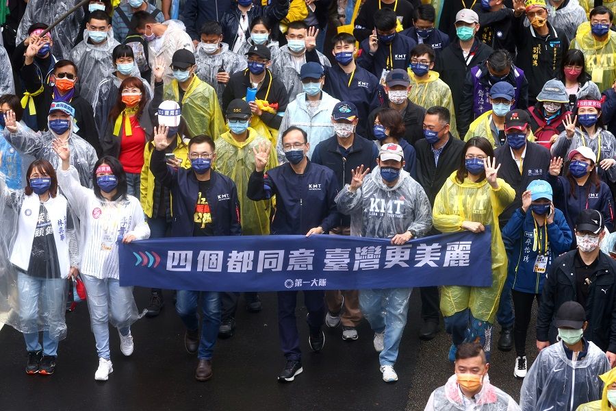 Former KMT chairman Johnny Chiang and incumbent KMT chairman Eric Chu join the annual Autumn Struggle labour protest, focusing on the opposition to the government's decision to allow imports of US pork containing ractopamine, and other issues related to the referendum in Taipei, Taiwan, 12 December 2021. (Ann Wang/Reuters)