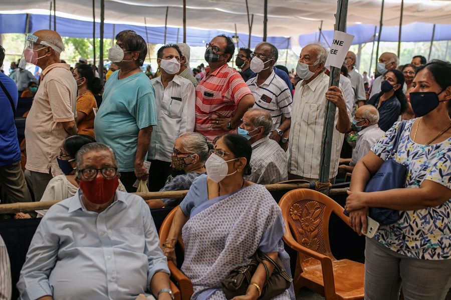 People in a waiting area at a Covid-19 vaccination centre at the NESCO jumbo Covid centre in the Goregaon suburb of Mumbai, India on 27 April 27. (Dhiraj Singh/Bloomberg)