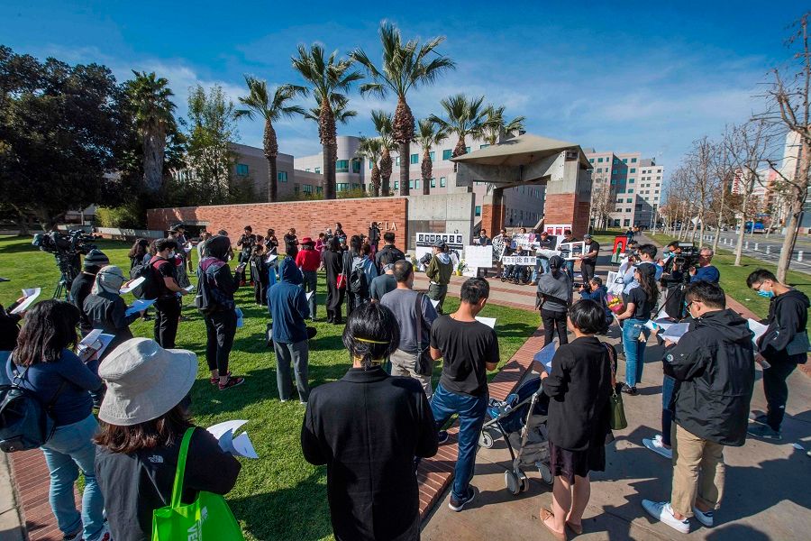 Chinese students and their supporters hold a memorial for Dr Li Wenliang outside the UCLA campus in Westwood, California, on 15 February 2020. (Mark Ralston/AFP)