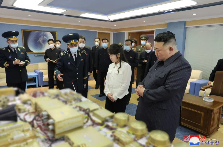 This picture taken on 18 April 2023 and released by North Korea's official Korean Central News Agency (KCNA) on 19 April 2023 shows North Korean leader Kim Jong Un (right) and his daughter, presumed to be named Ju Ae (second from right), inspecting the National Aerospace Development Administration (NADA) at an undisclosed place in North Korea. (KCNA via KNS/AFP)