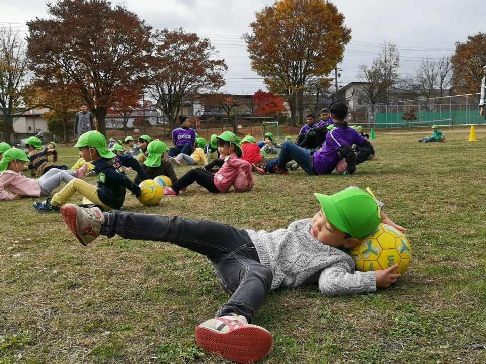 A Japanese boy stretching with a ball during a clinic arranged by J2 football club Matsumoto Yamaga with the Matsumoto City Kiri Kindergarten in Japan, in November 2018. (SPH Media)