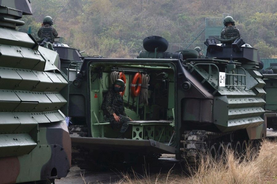 Navy officers travel in an Assault Amphibious Vehicle during the two-day routine drill by Taiwan's armed forces, at a military base in Kaohsiung, Taiwan, 12 January 2023. (Ann Wang/Reuters)