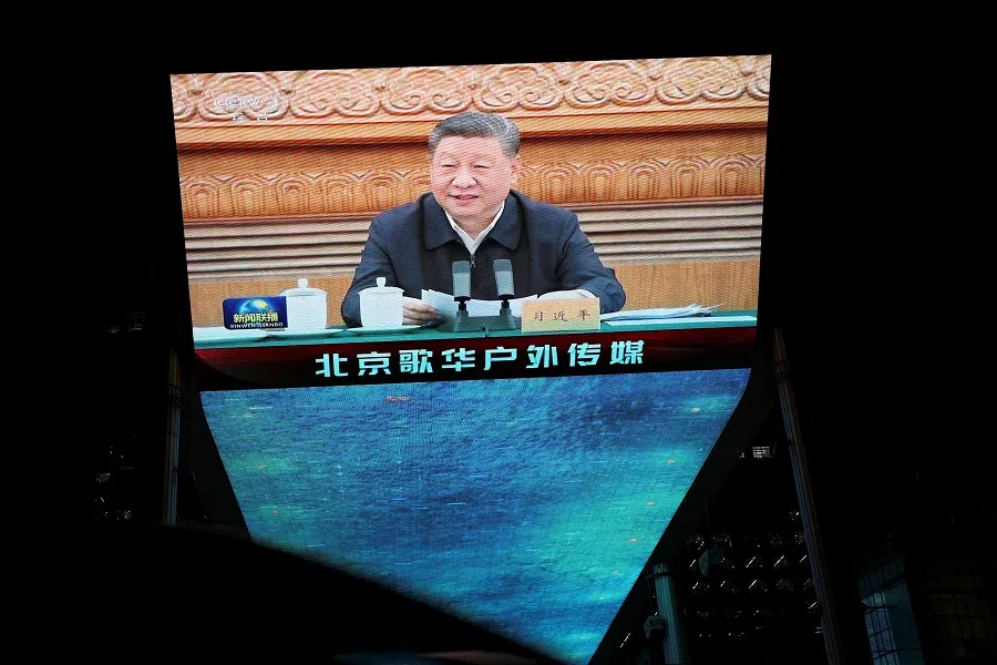 A giant screen shows news footage of Chinese President Xi Jinping attending a symposium on private enterprises, at a shopping complex in Beijing, China, on 17 February 2025.