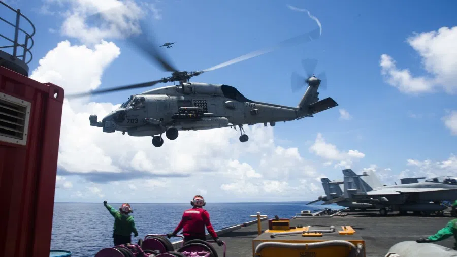 A helicopter lifts off the flight deck of USS Ronald Reagan in the South China Sea. (US Navy Mass Communication Specialist 2nd Class Codie L. Soule/US Navy website)
