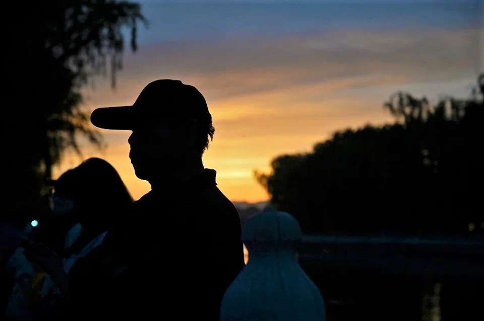 A man stands next to Houhai Lake during the sunset in Beijing, China on 16 May 2021. (Jade Gao/AFP)