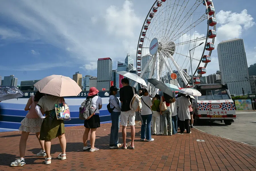 Tourists along Victoria Harbour in Hong Kong on 8 July 2024. (Peter Parks/AFP)