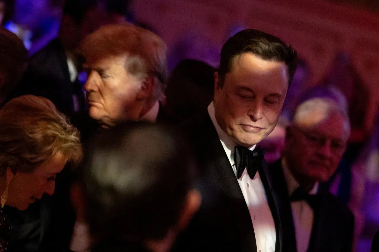 US President-elect Donald Trump walks by Elon Musk during the America First Policy Institute (AFPI) gala at Mar-A-Lago in Palm Beach, Florida, US, on 14 November 2024.