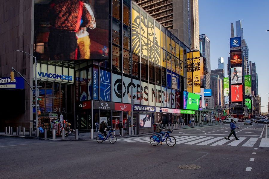 Cyclists cross a street in the Times Square neighbourhood of New York, US, on 8 April 2021. (Amir Hamja/Bloomberg)
