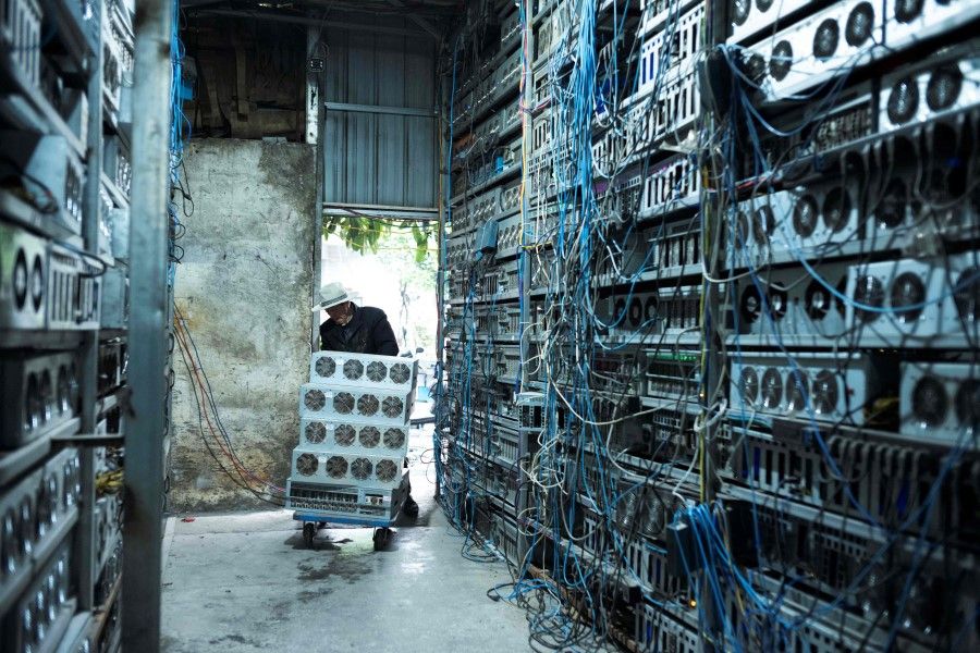 This photo taken on 6 April 2021 shows a local resident working part time at a cryptocurrency farm in Dujiangyan in China's southwestern Sichuan province. (STR/AFP)