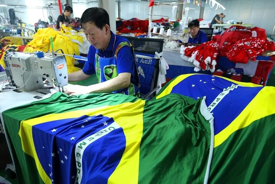 A worker makes Brazilian flags ahead of the World Cup football tournament, at a factory in Qingdao, in China’s Shandong province on 28 May 2026.